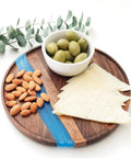 Solid Walnut Wood And Epoxy Resin Lazy Susan Turntable with cheese, almonds, and olives arranged elegantly.