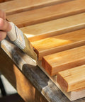 Applying Premium Clear Wood Stain With Semi Gloss Finish to wood slats for deck or fence weatherproofing.