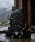 Dope Lightweight Hiking Backpack For Camping And Day Hikes, black, wet, against wooden wall, mug and rope in background