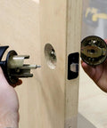 Lock Mate Plus Self Clamping Professional Door Lock Installation Kit for Wood and Metal Doors in use on thick wooden door.