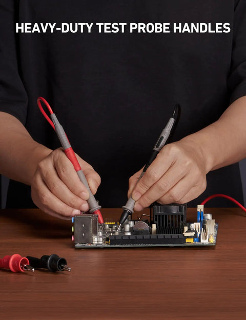 Person using 8-Piece Multimeter Test Leads Kit With Alligator Clips, Plunger Mini Hooks And Test Probes on motherboard.
