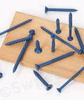 52 Piece Concrete Screw Anchor Kit With Drill Bit And Screwdriver Bit Swpeet Included, blue cement screws on wood surface.