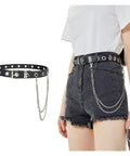 Badass Punk Grommet Leather Belt With Detachable Silver Chain Unisex Adjustable Waist Strap For Ripped Jeans Streetwear Flex And Everyday Rocker Vibes Style on model with distressed shorts.