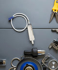 Heavy Duty Manual Fluid Extraction Pump For Automotive Engine Oil Transfer Tool on a workspace among various tools.