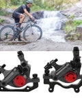 Heavy Duty Aluminum Disc Brake Set Delivers Beast Mode Stopping Power With A Slick No Fuss Setup That Crushes It For Mountain Trails Or Daily City Rides Keeps You Secure All Day Black, shown alongside a cyclist.