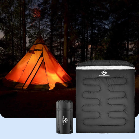 Two Person Sleeping Bag For All Seasons With Wraparound Zippers in forest with glowing tent, XL size for camping comfort.