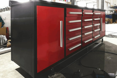 Rock Solid Ten Foot Heavy Steel Workbench And Tool Cabinet Featuring Fifteen Locking Drawers And Pre Cut Non Slip Liners For Your No Nonsense Garage Setup, side view with red cabinets.