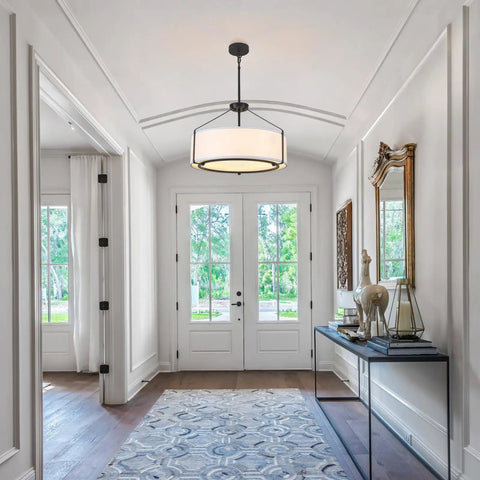 Grab This 20 Inch Drum Chandelier With 5 Lights For Instant Modern Farmhouse Vibes Featuring Soft White Linen Shades And Sleek Black Frames illuminating an entryway.
