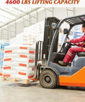Orange forklift with driver lifting a pallet of stacked white sacks in a warehouse.