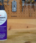 Stuck Bolts And Nuts Teflon Penetrant Aerosol 10 Oz can on workbench with tools in background, rust protection for hardware.