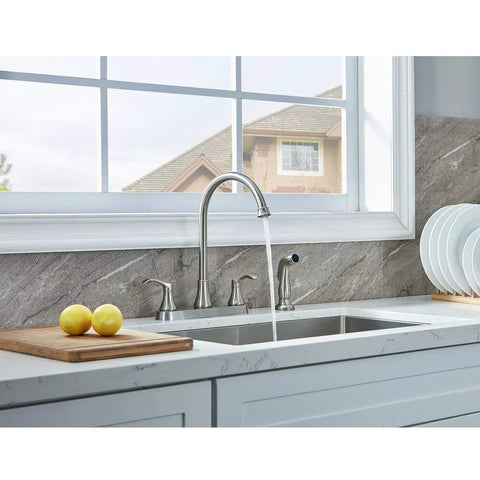 Sleek Brushed Nickel Kitchen Faucet Featuring Pull Out Side Spray in modern kitchen with lemons and window view.