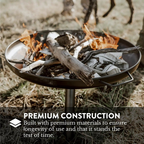 Outdoor Wood Burning Fire Pit 23 Inch Durable Alloy Steel with firewood and flames burning on the ground, perfect for gatherings.