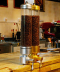 Wall Mounted Transparent Coffee Canister With Gold Trim And Smooth Grip Handle Straight Up Fantastic Dry Food Dispenser for coffee beans.