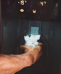 Hand using Whirlpool Ice Maker Replacement W10190952 For Whirlpool Refrigerators to dispense ice into a glass