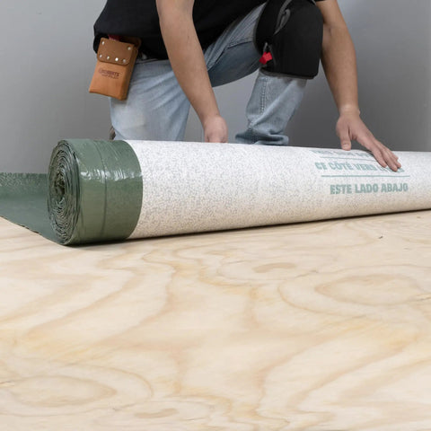 Real Deal 3 In 1 Flooring Underlayment Roll For Laminate And Engineered Wood shown being unrolled on plywood subfloor.