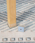 Square Felt Furniture Pads 1 1/4 To 1 3/8 Inch Self Adhesive Floor Protectors on wooden chair leg.