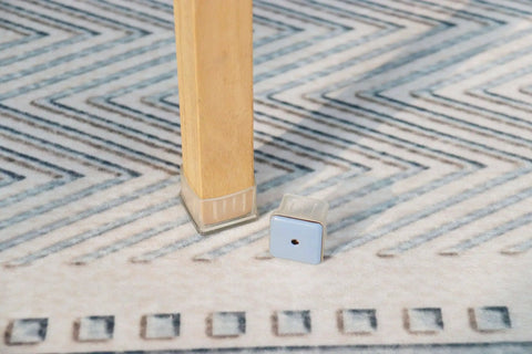Square Felt Furniture Pads 1 1/4 To 1 3/8 Inch Self Adhesive Floor Protectors on wooden chair leg.