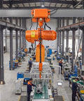 Velvet-Vision VEVOR 4400 Pound Electric Chain Hoist With Power Trolley over factory floor with workers and machinery.