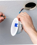 Hands installing recessed light using 50 Pcs Recessed Light Clips Spring Clips For Downlight Installation in ceiling