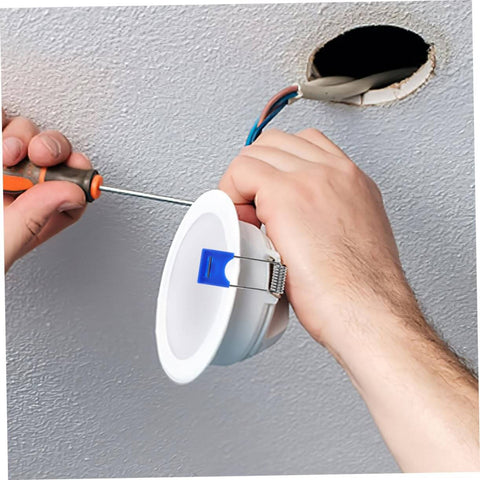 Hands installing recessed light using 50 Pcs Recessed Light Clips Spring Clips For Downlight Installation in ceiling