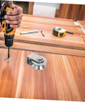 Person drilling hole near Stainless Steel Fixed Pulley Bearing For Sliding Doors And Gates on wooden surface