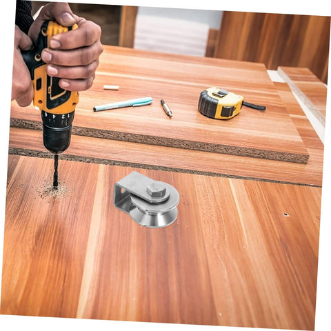 Person drilling hole near Stainless Steel Fixed Pulley Bearing For Sliding Doors And Gates on wooden surface
