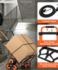 Heavy Duty Stair Climbing Hand Truck With Quick Fold Frame And Smooth Rolling Wheels For Zero Stress Moving No Sweat 300 Lb Cargo Hauler carrying a large cardboard box up stairs.