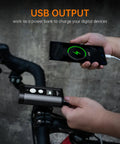 Person using PR2400 2400 Lumen Mountain Bike Light With OLED Runtime Display USB Output to charge a phone on bike handlebars