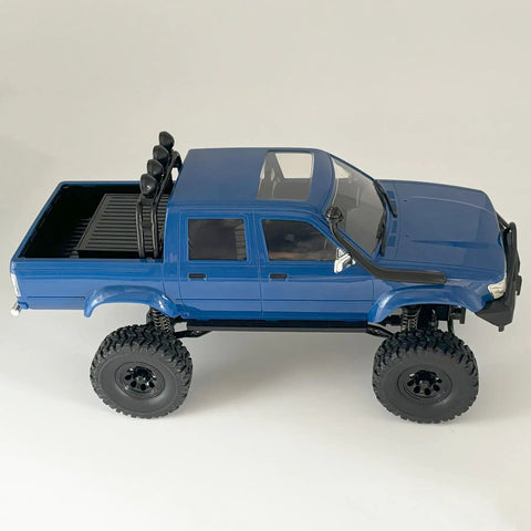 Side view of blue Beefed Up 1/16 Scale RC Rock Crawler With 4x4 Drive All Terrain Off Road Pickup RTR Hobby Grade Vehicle on white background