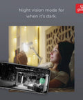 Woman using phone app to view Smart WiFi Security Light With Camera, 24W LED, 1600 Lumens, Motion Sensor, night vision mode.