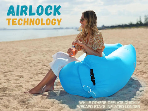 Inflatable Couch Air Lounger Chair For Camping And Beach Trips Portable Blow Up Sofa on a beach with a person seated.