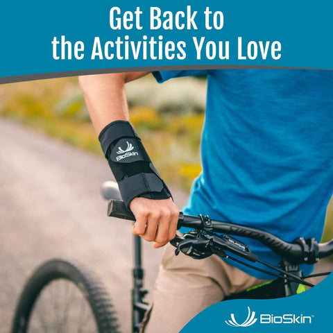 Person wearing Carpal Tunnel Wrist Brace for arthritis pain relief on a bike, providing support with adjustable straps.
