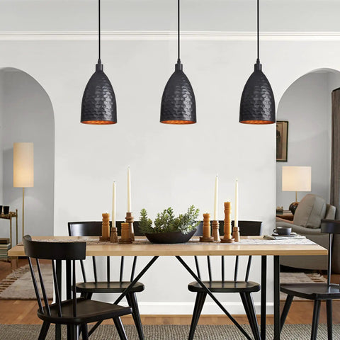 Black Metal 3 Light Pendant Light With Adjustable Height Up To 76.6 Inches hanging over dining table in industrial farmhouse style