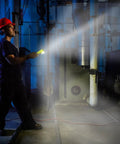 Worker using Dualie 275 Lumen Multi Function Intrinsically Safe Rechargeable Flashlight with Magnetic Clip in industrial setting.