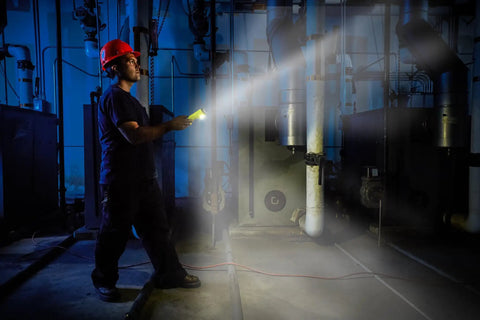 Worker using Dualie 275 Lumen Multi Function Intrinsically Safe Rechargeable Flashlight with Magnetic Clip in industrial setting.