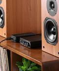 36V 6A Power Supply GaN Adapter with amplifier and speakers on a wooden shelf, showing compact and efficient setup.