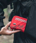 Person holding Grab And Go Small Ultralight First Aid Kit For Hiking And Travel, Water Resistant Medical Kit Weighing Just 20g in a pocket