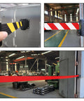 Heavy Duty Retractable Queue Barrier With Smooth As Butter Retractor High Visibility Red White Belt installed in a warehouse.