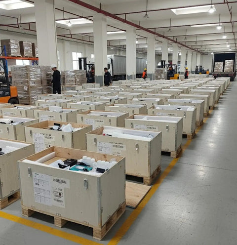 Industrial warehouse with multiple wooden crates lined up, containing 13 Inch DTF Printer With Industrial Print Head High Speed DTF Printing Machine For T Shirts Textile And Garment Pro Level Heat Transfer Printer For Small Biz And Home Use Complete Printing System.