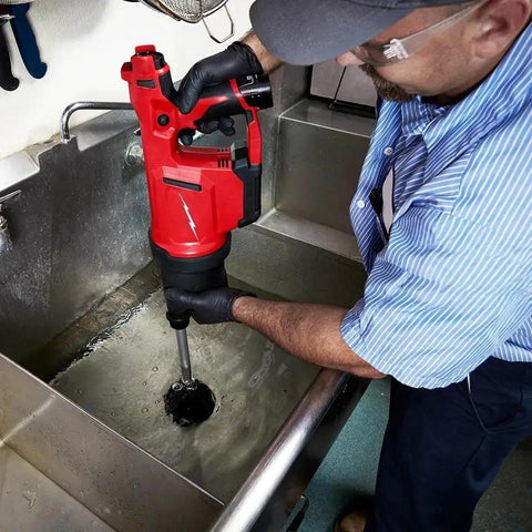 Cordless Drain Cleaning Air Gun Kit With Variable Pressure Control And Quick Swap Auger Tips For Sinks Toilets And Drains quickly unblocks nasty pipe clots fast being used in a sink.