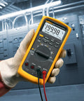 Technician using Beefed Up Pro Grade Industrial Digital Multimeter For Troubleshooting With 1000 Volt AC DC Range, Peak Min Max.