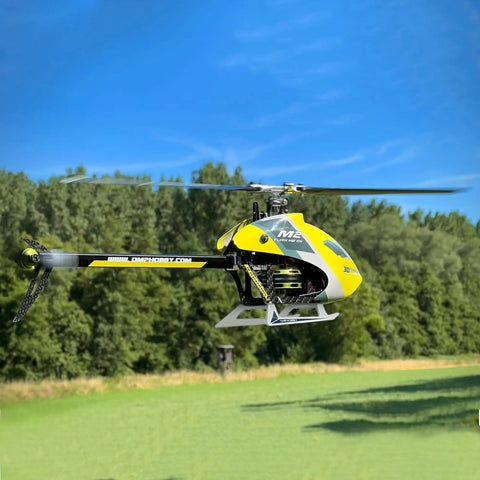 Ready To Fly Pro Grade RC Helicopter with dual brushless motors in flight, 6CH remote, outdoor 3D flight over grassy field.