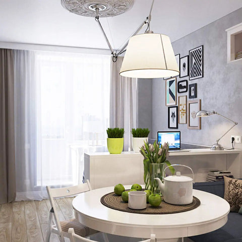 Modern dining room with white furniture, pendant light, and decorative wall art
