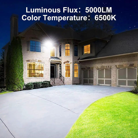 Two Pack 100W LED Outdoor Flood Lights illuminating a house driveway at night, showing weatherproof security lighting.