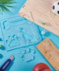 Clear Acrylic 3 In 1 Dog Bone And Paw Router Template Set For Woodworking No Fuss Reusable Jig Stencils For DIY Projects Bee Inlay Inspired Craft Templates 7.8 Inch Square 6mm Thick on blue surface with craft tools