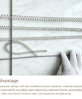 Heavy Duty 304 Stainless Steel Long Compression Extension Spring With 0.5mm Wire And 5mm Outer Diameter on marble surface.