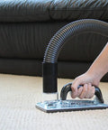Sub Surface Extraction Tool 71 001 for carpet cleaning and odor elimination used on beige carpet near a black couch.