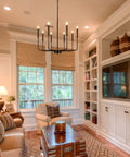 8 Light Matte Black Farmhouse Chandelier With Adjustable Height For Dining Room Living Room Kitchen Island And Bedroom, Classic Candle Stem Design, Industrial Rustic Ceiling Light Fixture in cozy living room.