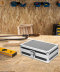 Rugged As Nails Portable Aluminum Tool Box With Secure Locking Lid on a workbench, durable black finish and sturdy latches.