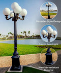 9.5 Ft Five Arm Victorian Outdoor Post Light in Black Finish with Shatterproof Globe Shades by a Lake